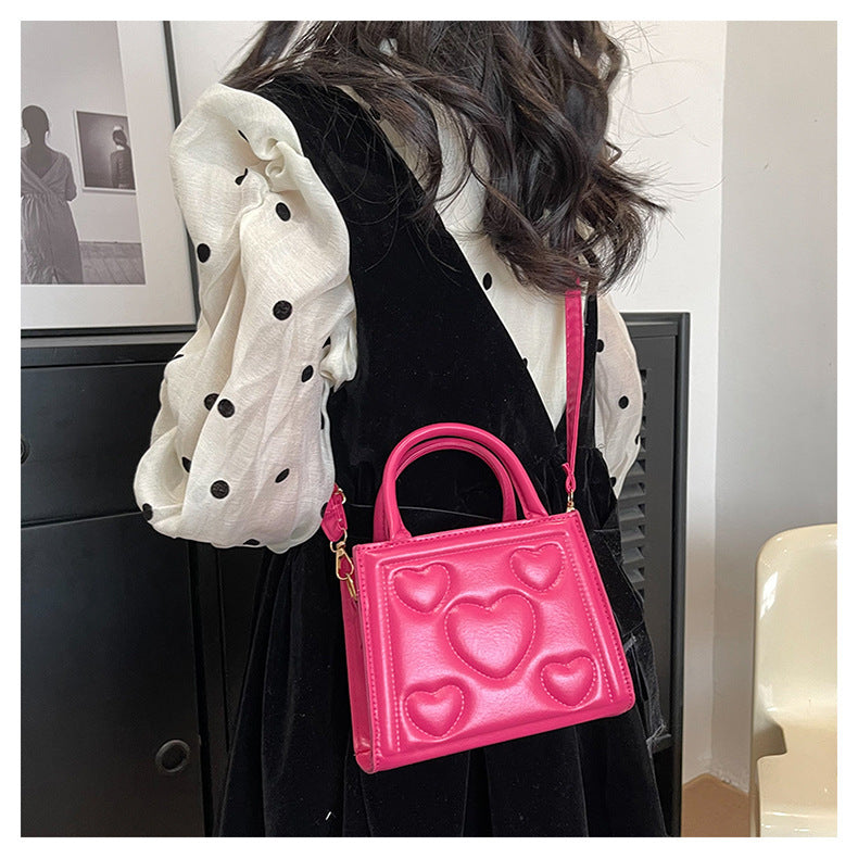 1pc Women’s Stylish Solid Color Handbag with Detachable Strap – Heart Pattern Design, Perfect for Valentine’s Day Gift, Available in Magenta, White, Black, Green, Yellow